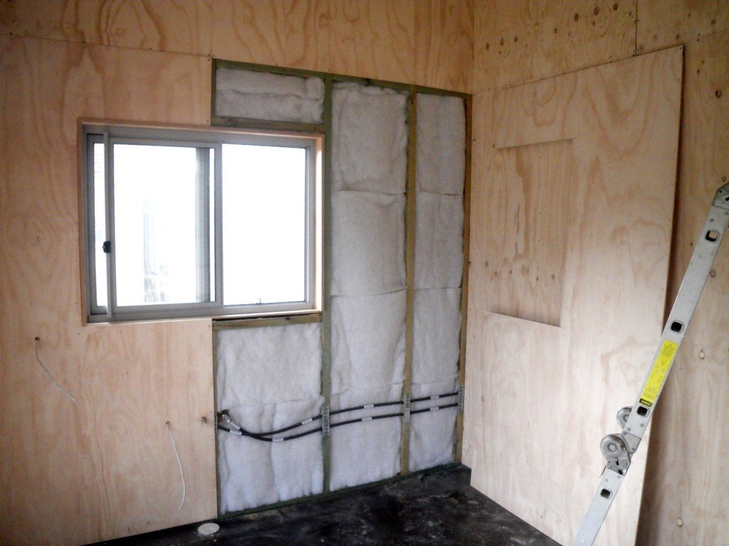 Polyester batt insulation in the Greeny Flat walls